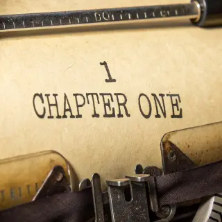 The word 'CHAPTER ONE' typed on aged paper with a vintage ty