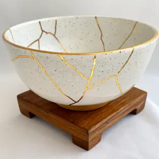 A Japanese kintsugi bowl — cracked ceramic repaired with vis
