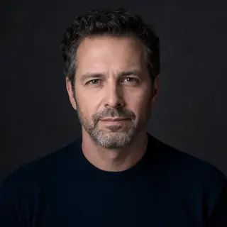 A portrait of a middle-aged man with a calm, serious express