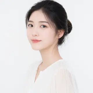 A high-key portrait of a person against a bright white backg