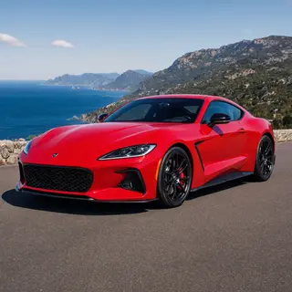 A bright red sports car parked on a gray asphalt road — the 