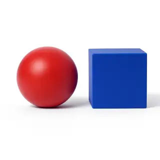 A red ball and a blue cube sitting side by side on a white s