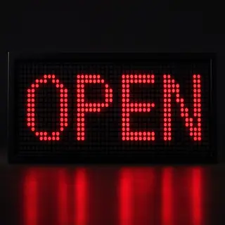 The word 'OPEN' displayed on a red LED sign with glowing pix