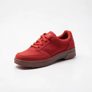 A single red sneaker on a clean white background with soft s