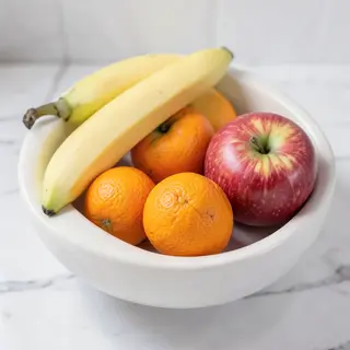 A fruit bowl containing exactly 3 bananas, 4 oranges, and 2 