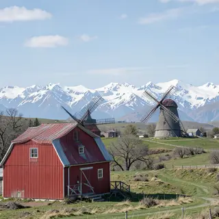 A landscape with a red barn in the foreground at large scale
