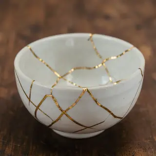 A Japanese kintsugi bowl — cracked ceramic repaired with vis