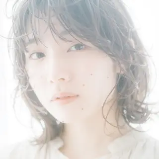 A high-key portrait of a person against a bright white backg