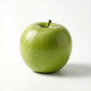 A ripe green apple on a seamless white background with soft 