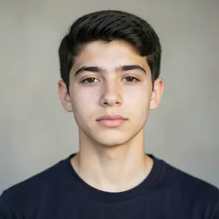 A headshot of a teenager with a relaxed, neutral face