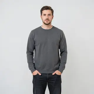 A man standing straight facing the camera, hands in pockets,