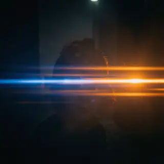 A cinematic frame with blue and orange anamorphic lens flare