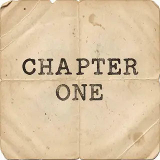The word 'CHAPTER ONE' typed on aged paper with a vintage ty