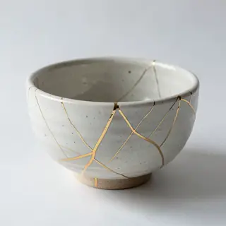 A Japanese kintsugi bowl — cracked ceramic repaired with vis