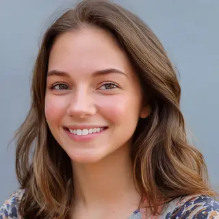A close-up portrait of a young woman with a warm natural smi