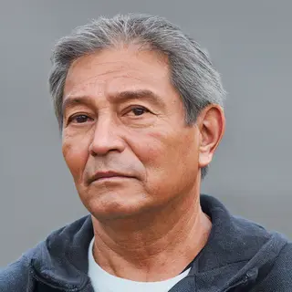 A portrait of a middle-aged man with a calm, serious express