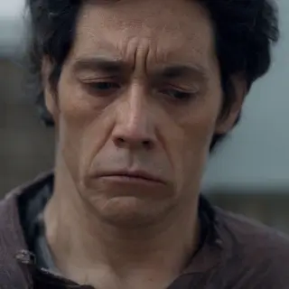 A face showing quiet melancholy — downcast eyes, slightly dr