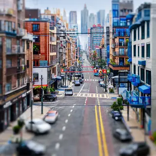 A tilt-shift photograph of a city street making real-life lo