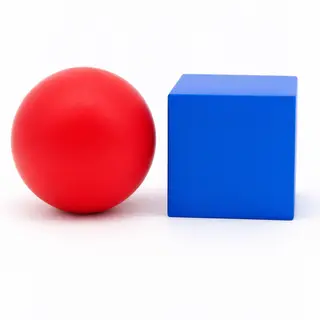 A red ball and a blue cube sitting side by side on a white s