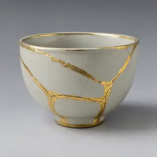 A Japanese kintsugi bowl — cracked ceramic repaired with vis