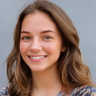 A close-up portrait of a young woman with a warm natural smi