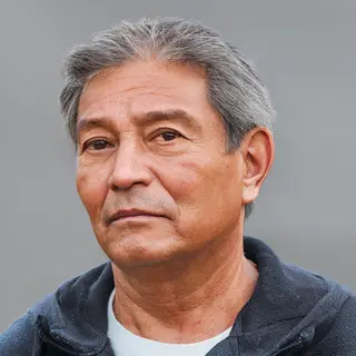 A portrait of a middle-aged man with a calm, serious express