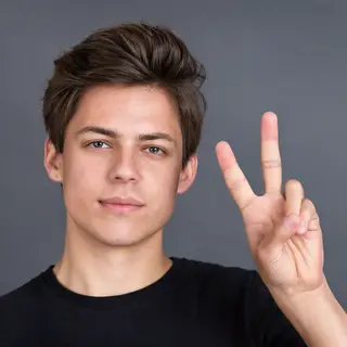 A person making a peace sign with their right hand, clearly 