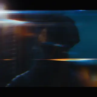 A cinematic frame with blue and orange anamorphic lens flare
