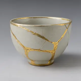A Japanese kintsugi bowl — cracked ceramic repaired with vis