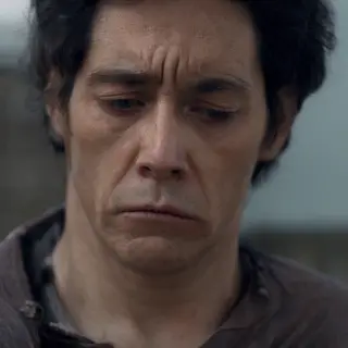 A face showing quiet melancholy — downcast eyes, slightly dr