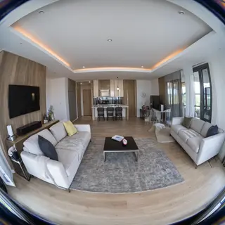 A wide-angle shot of a modern living room interior showing e