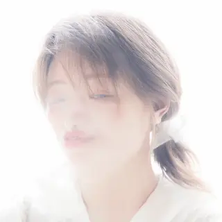A high-key portrait of a person against a bright white backg