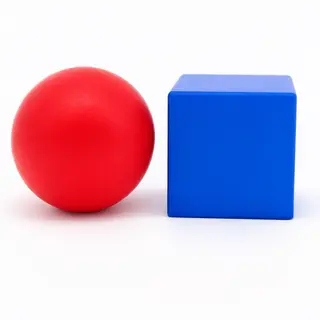 A red ball and a blue cube sitting side by side on a white s