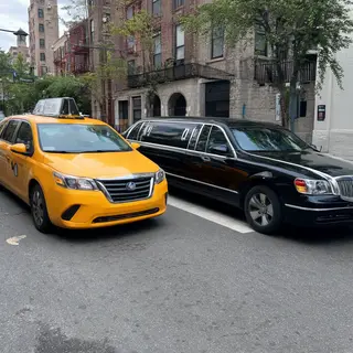 A yellow taxi and a black limousine parked next to each othe