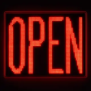 The word 'OPEN' displayed on a red LED sign with glowing pix
