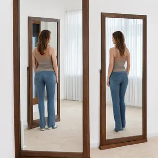 A woman standing in front of a full-length mirror, her refle