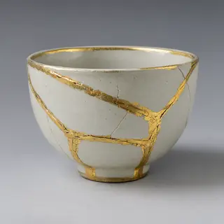 A Japanese kintsugi bowl — cracked ceramic repaired with vis