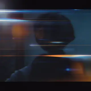 A cinematic frame with blue and orange anamorphic lens flare