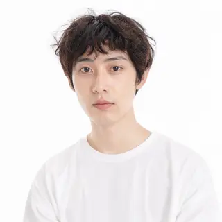 A high-key portrait of a person against a bright white backg