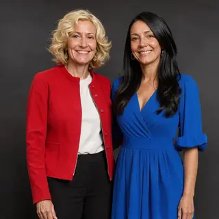 Two women standing side by side: one with short blonde hair 