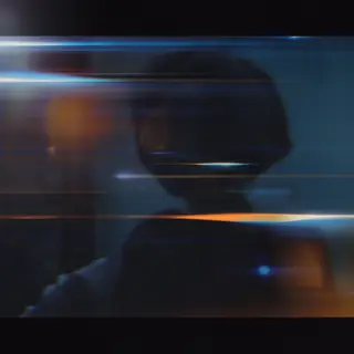 A cinematic frame with blue and orange anamorphic lens flare