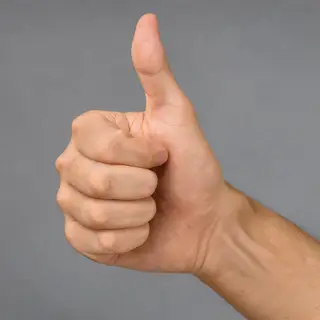 A hand giving a thumbs-up with four fingers curled and thumb