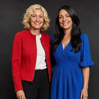 Two women standing side by side: one with short blonde hair 