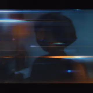 A cinematic frame with blue and orange anamorphic lens flare