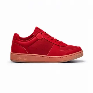 A single red sneaker on a clean white background with soft s