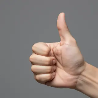 A hand giving a thumbs-up with four fingers curled and thumb