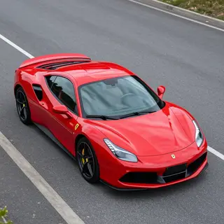 A bright red sports car parked on a gray asphalt road — the 