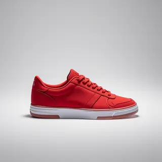 A single red sneaker on a clean white background with soft s