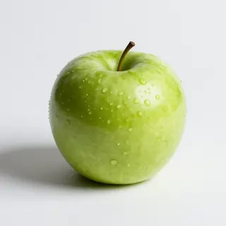 A ripe green apple on a seamless white background with soft 
