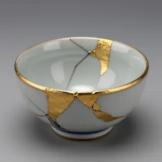A Japanese kintsugi bowl — cracked ceramic repaired with vis